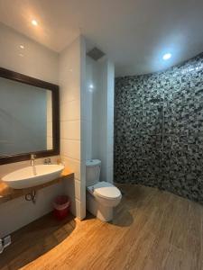 a bathroom with a sink and a toilet and a mirror at Orova Hotel in Ấp Phú Thọ +43 photos