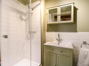 a bathroom with a sink and a shower at The Hayloft - Beautiful Barn Stay in Ashford +39 photos