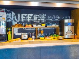 a kitchen with a counter with food on it at ibis budget Carcassonne La Cité in Carcassonne