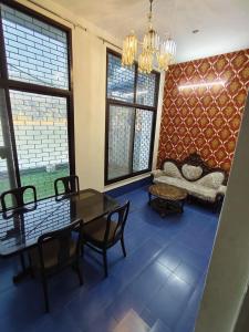 a living room with a table and chairs and a couch at hotel tripta ganga in Rishīkesh