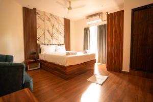 a bedroom with a bed and a large window at Lume Stayz in Siolim +64 photos