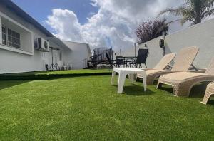 a group of chairs and a table on a lawn at Don Leon Boutique in Even Menahem