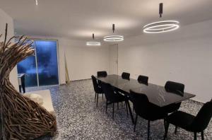 a conference room with a table and black chairs at Don Leon Boutique in Even Menahem +49 photos