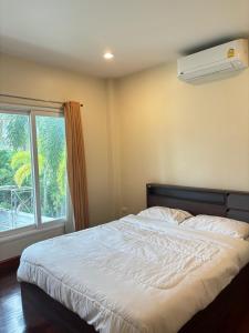 a bedroom with a white bed and a window at NS Private Pool villa in Ban Na Kok +44 photos
