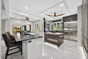 a kitchen with black and white appliances and a counter at Casa Lotus in San Juan