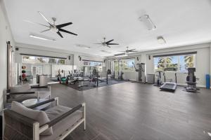 a gym with several treadmills and chairs in a room at Casa Lotus in San Juan