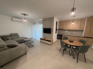 a living room with a couch and a table at Apartments Svetlana, Igalo in Herceg-Novi