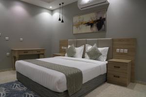 a bedroom with a large bed with white sheets and pillows at اجنحة نزيل & اجنحة الشمال in Tabuk +31 photos