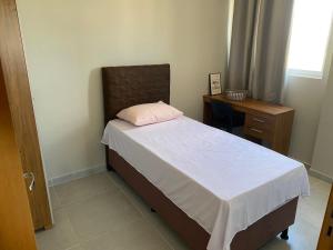 En eller flere senge i et værelse på Residencial T&D V