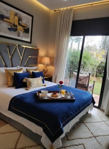 una camera da letto con un letto con un vassoio di cibo sopra di Atlas Golf resort a Marrakech