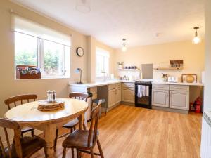 a kitchen with a table and a table and chairs at 2 Horseshoe Road in Montgomery