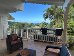 a balcony with a view of the ocean at Studio La Marguerite - Vue mer avec terrasse privée - calme tropical à Deshaies in Deshaies