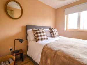 a bedroom with a bed with a mirror on the wall at 2 Horseshoe Road in Montgomery