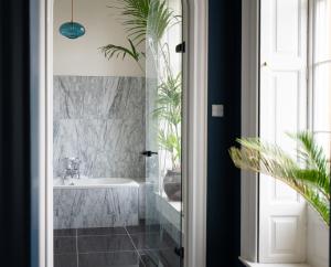 a bathroom with a bath tub and a sink at Wren Place Hall in Barnsley +65 photos