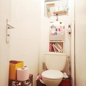 une salle de bain avec des toilettes blanches dans une chambre dans l'établissement Book A Rest Paris, à Longjumeau