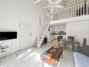 a living room with a couch and a table at Mango Vert Duplex - Orient Bay in Saint Martin
