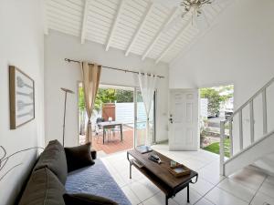 a living room with a couch and a table at Mango Vert Duplex - Orient Bay in Saint Martin +5 photos