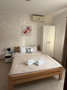 a bedroom with a bed with two towels on it at Apartmani Marković in Tivat