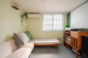 a living room with a couch and a table at Pachira House in Seoul