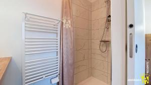 a shower with a glass door in a bathroom at Buron St Roch in Murol
