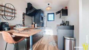 a kitchen with a table and a refrigerator at Buron St Roch in Murol