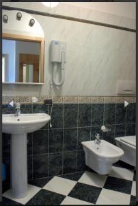 a bathroom with a sink and a toilet and a mirror at Residence Alice in Celledizzo +71 photos