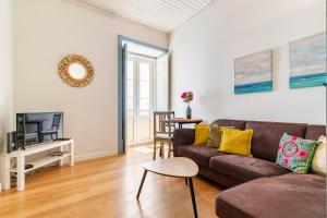 a living room with a couch and a tv at Casa Oliveira in Lagos