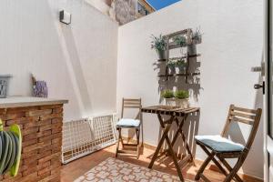 a small balcony with a table and two chairs at Casa Oliveira in Lagos