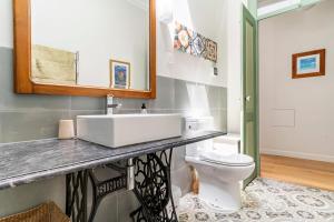 a bathroom with a sink and a toilet at Casa Oliveira in Lagos +24 photos