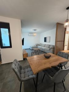 a living room with a wooden table and chairs at Apartments Svetlana, Igalo in Herceg-Novi