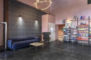 a store with a blue couch and a table in a room at B&B Hotel Passo Tre Croci Cortina in Cortina dʼAmpezzo +41 photos