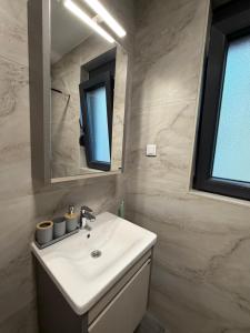 a bathroom with a sink and a mirror at Apartments Svetlana, Igalo in Herceg-Novi +98 photos