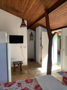 a bedroom with a bed and a tree in a room at Pousada Chic N Choc in Morro de São Paulo +71 photos