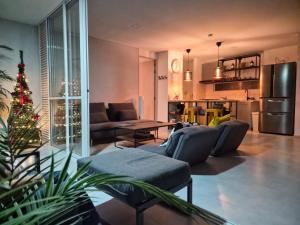 a living room with a couch and a christmas tree at Citadela Di Sole Tropical Escape in Santa Fe de Antioquia