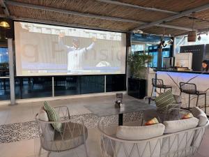 a man on a screen in front of a presentation at Pullman Dubai Jumeirah Lakes Towers in Dubai
