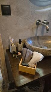 a bathroom with a sink and a counter with towels at Black Rock Agria in Agria +26 photos