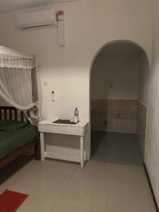a room with a bed and a table in a room at Seasong Rooms in Unawatuna