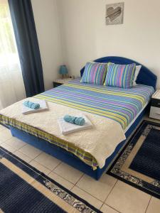 a bed with towels on it in a room at Apartmani Marković in Tivat