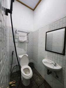 un bagno con un water e un lavandino di Champrink Surfcamp a Wainapal