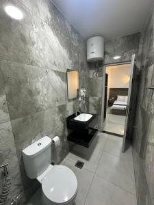 a bathroom with a toilet and a sink and a mirror at Happy Beach Castel for Apartment قلعة شاطئ السعادة للشقق المفروشة in Aqaba +85 photos