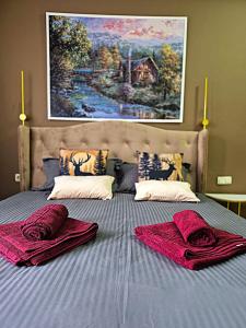 a bed with two red towels on top of it at OTILIA apartment in Zell am See