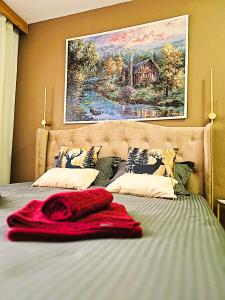 a bed with a red blanket on top of it at OTILIA apartment in Zell am See