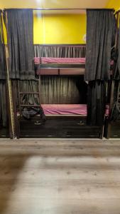 a room with two bunk beds in a room at Shri Ashray in Varanasi