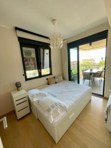 a bedroom with a bed and a chandelier at Apartment Zoe in Tivat