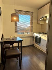 a kitchen with a table and a dining room at Cietokšņa 64 in Daugavpils