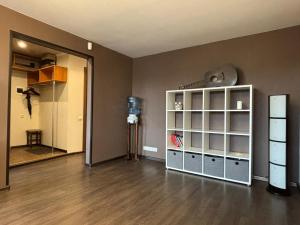 a living room with a white cabinet and a mirror at Cietokšņa 64 in Daugavpils
