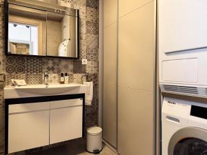 a bathroom with a sink and a washing machine at Apartment Zoe in Tivat +26 photos