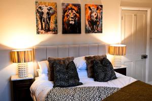 a bedroom with a bed with three pictures on the wall at The Walmer Retreat in Deal