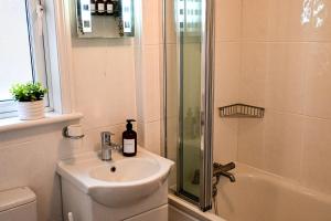 a bathroom with a sink and a shower at The Walmer Retreat in Deal +30 photos