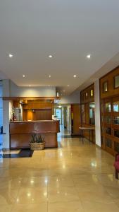 a lobby of a hotel with a counter and a table at Gran Lourdes Hotel in Villa Carlos Paz +44 photos